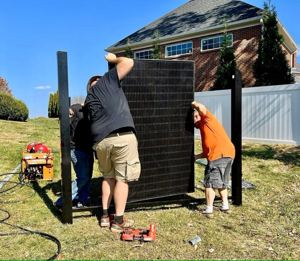 solar fence supplies: picture of A to Z Quality Fencing and Sol Fence assembling a fence panel